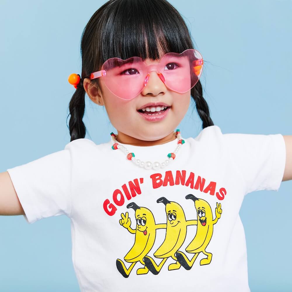 little girl wearing a goin' bananas t-shirt
