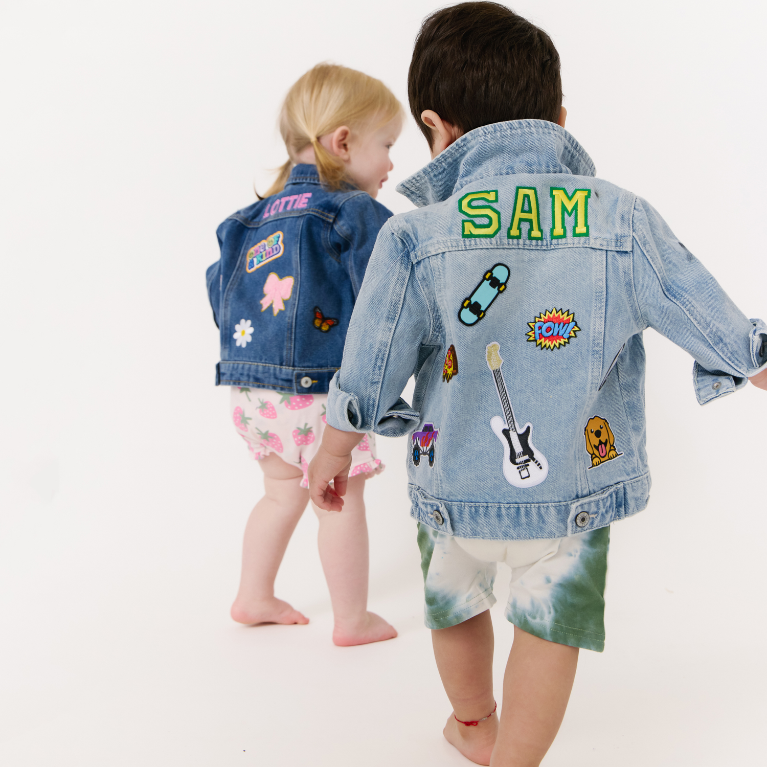 Kids wearing personalized denim jackets with names and patches