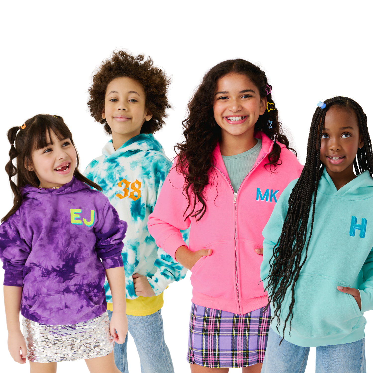 Four kids wearing personalized hoodies and zip-up sweatshirts with embroidered initials and numbers — purple tie dye, teal tie dye, pink zip-up and mint hoodie on a white background