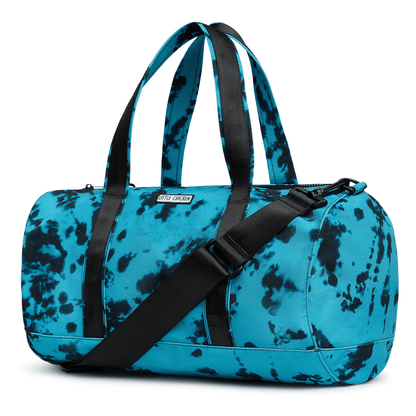 Blue and black tie dye duffel bag with a black strap on a white background
