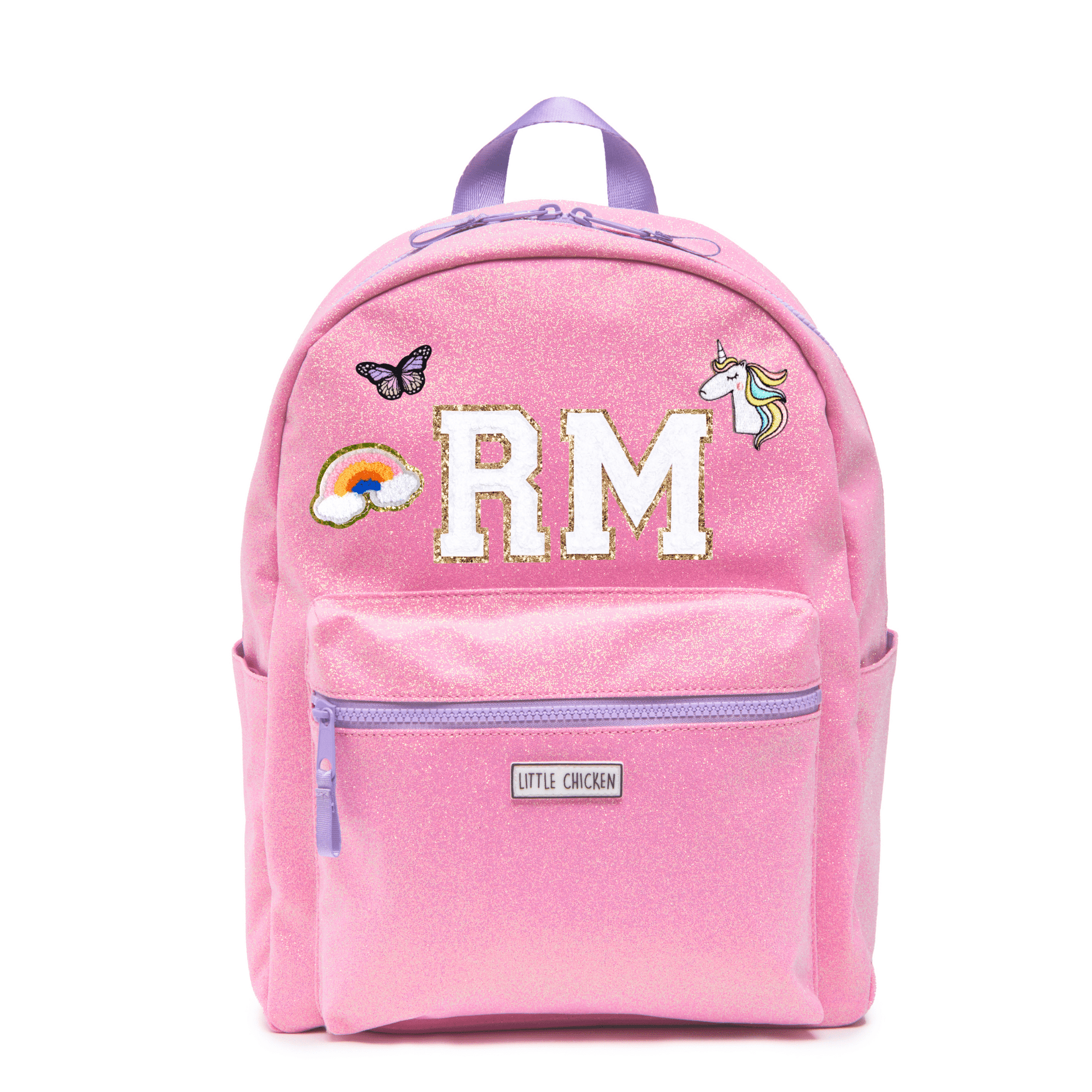 Pink backpack with 'RM' initials, a rainbow, butterfly, and unicorn patch on a white background.