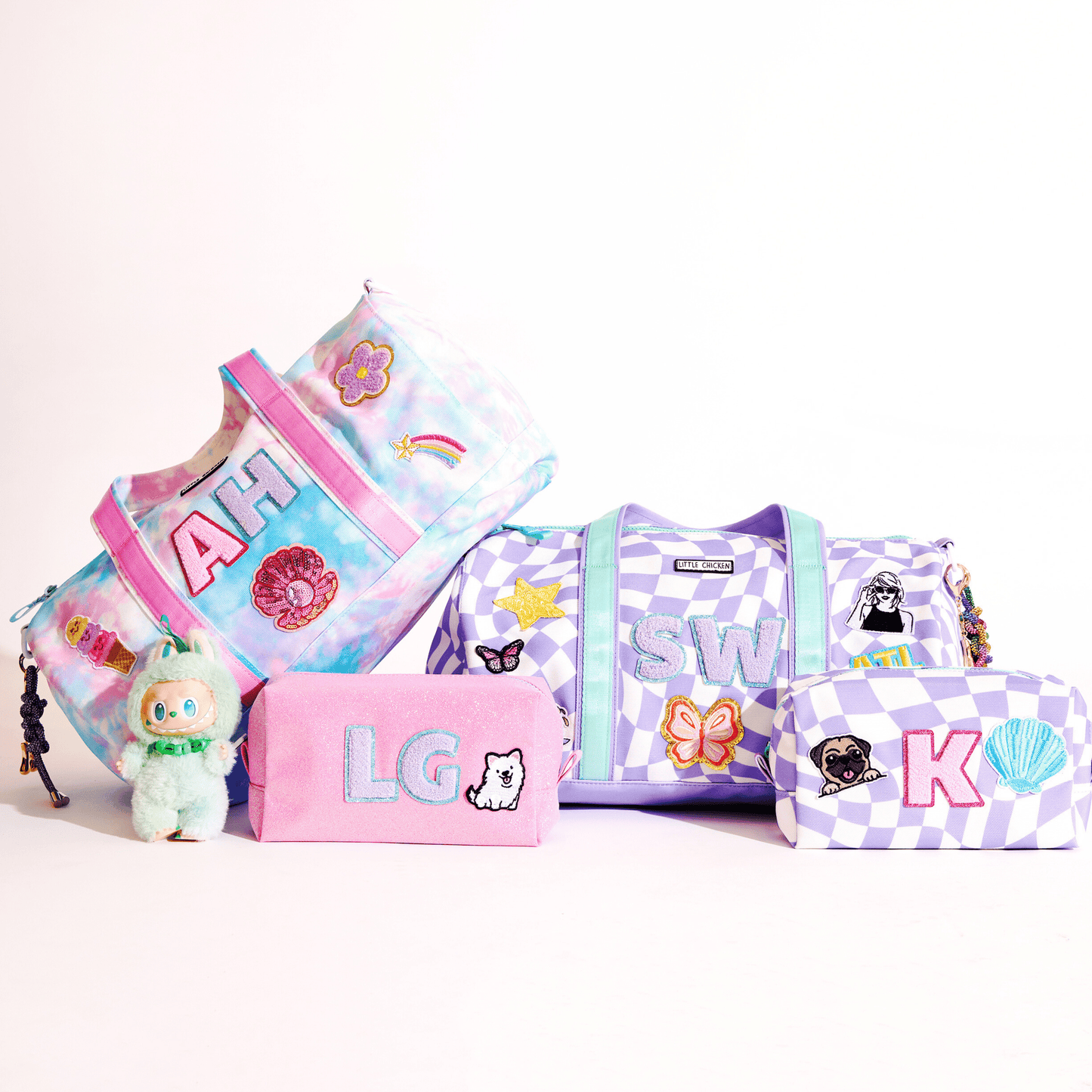 Set of colorful custom  duffels and pouches with patches  on a white background