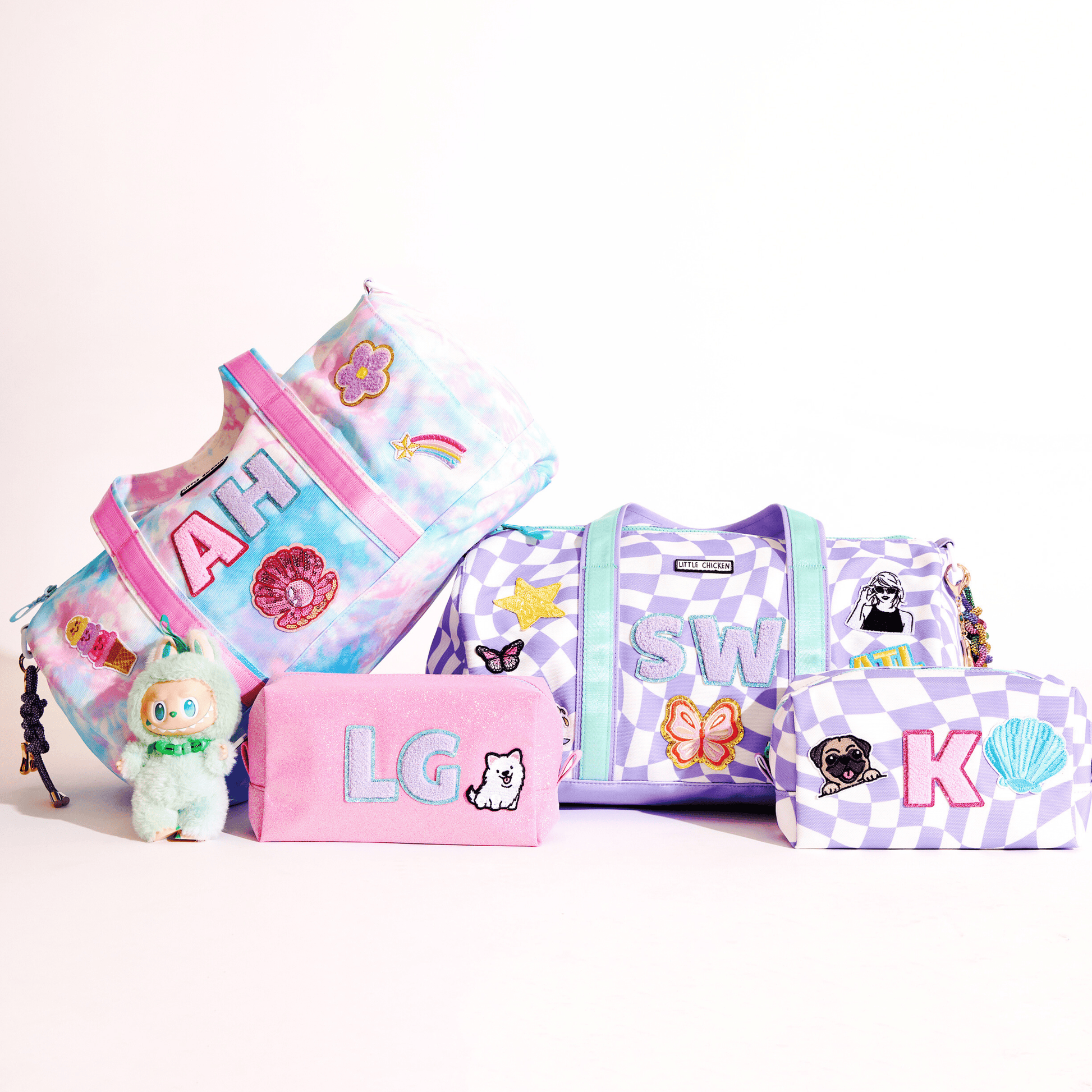 Set of colorful custom  duffels and pouches with patches  on a white background