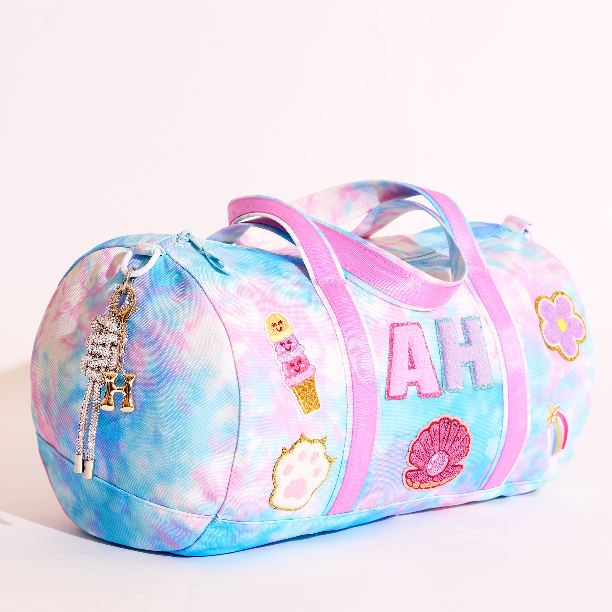 Colorful duffel bag with decorative elements on a white background