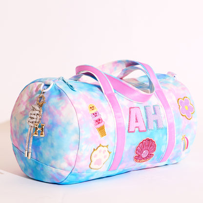 Colorful duffel bag with decorative elements on a white background