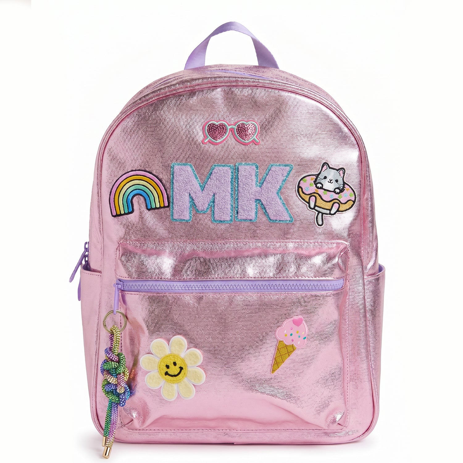 Personalized metallic pink kids backpack with custom initials and colorful patches including a rainbow, smiley flower, cat, ice cream cone and heart sunglasses. Features a front zip pocket, side pockets and spacious storage for school, camp and travel.