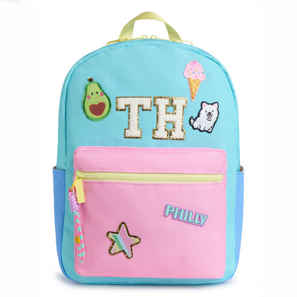 Personalized pastel kids backpack featuring custom initial patches, avocado, ice cream, puppy, star and city name patches. Includes front zip pocket, side pockets and spacious storage for school, camp and travel.