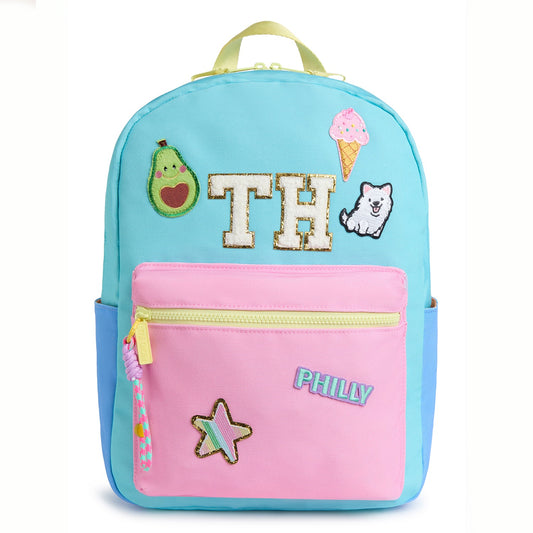 Personalized pastel kids backpack featuring custom initial patches, avocado, ice cream, puppy, star and city name patches. Includes front zip pocket, side pockets and spacious storage for school, camp and travel.