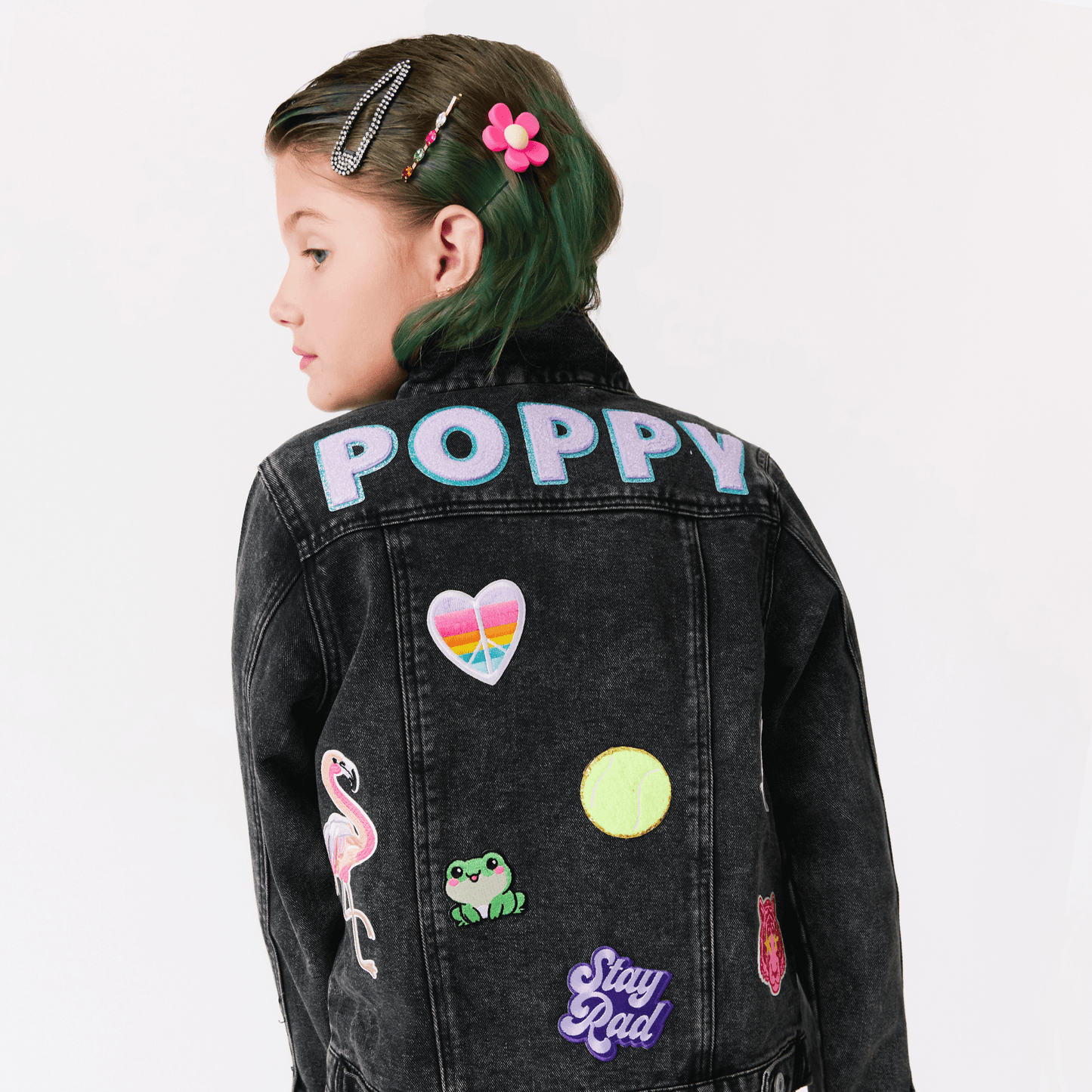 kid in a custom black denim jacket with colorful patches and monogram name