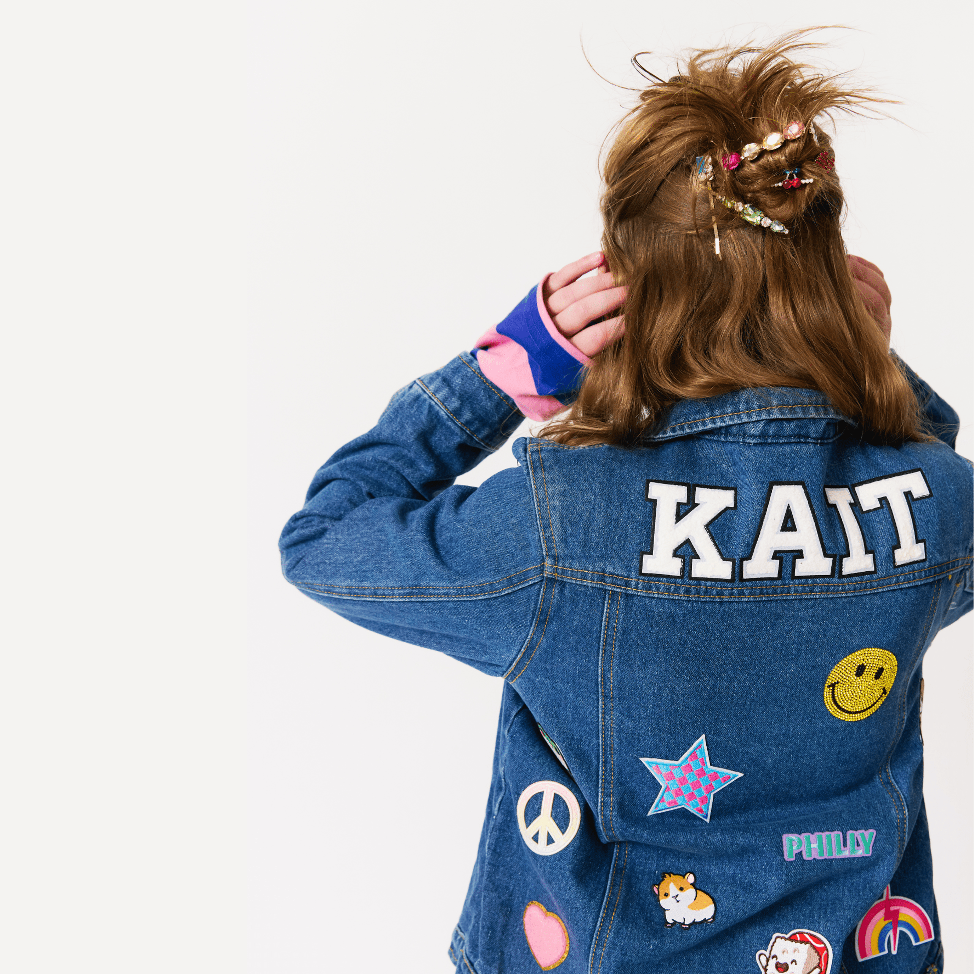 girl wearing a customized denim jacket with patches