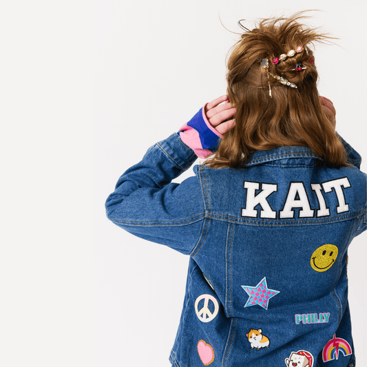 girl wearing a customized denim jacket with patches