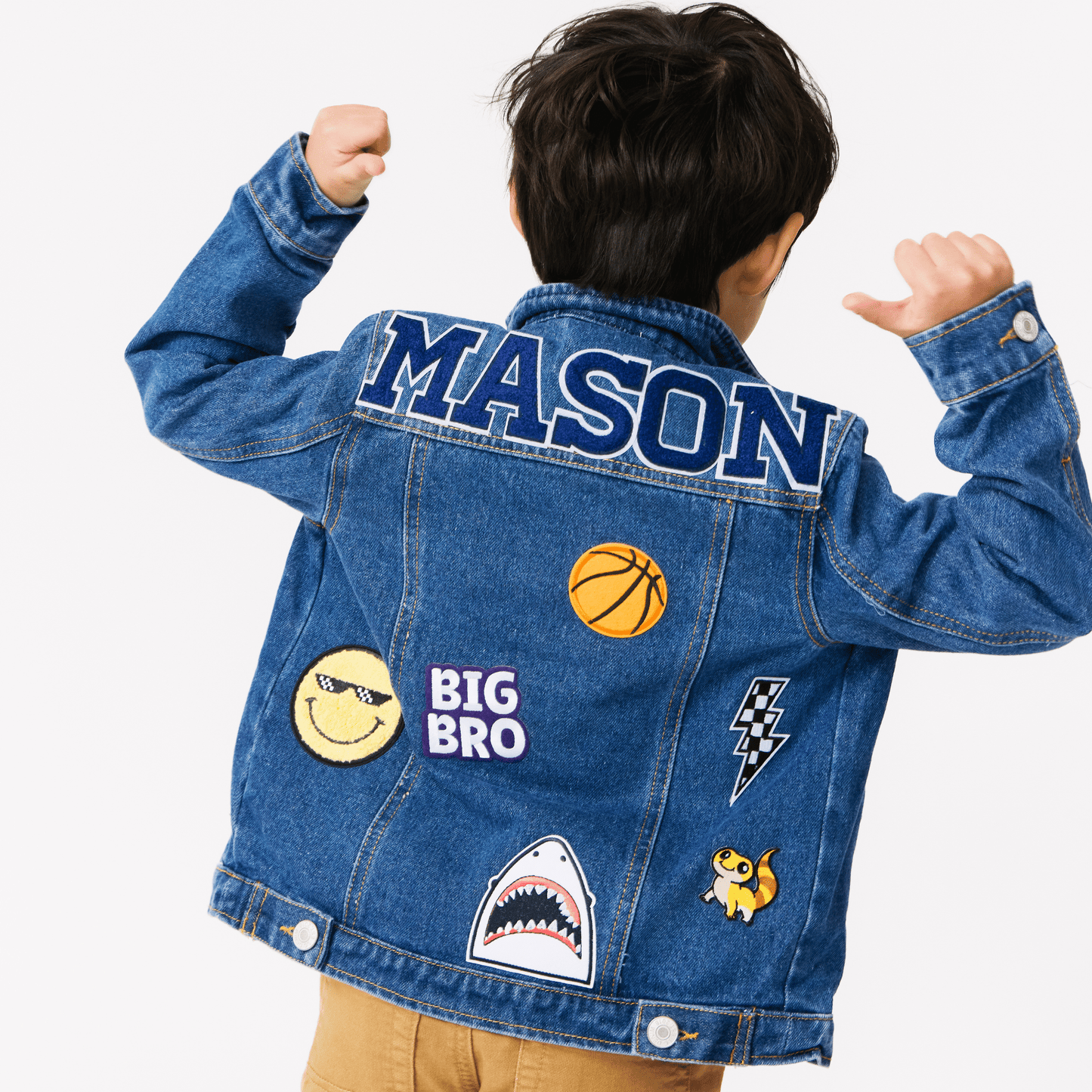 a boy wearing a customized denim jackets with various colorful patches on them. The jackets are adorned with different designs and name patches