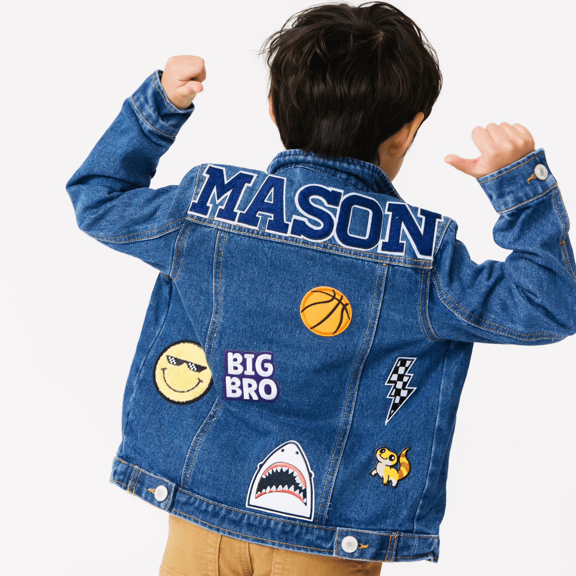 a boy wearing a customized denim jackets with various colorful patches on them. The jackets are adorned with different designs and name patches