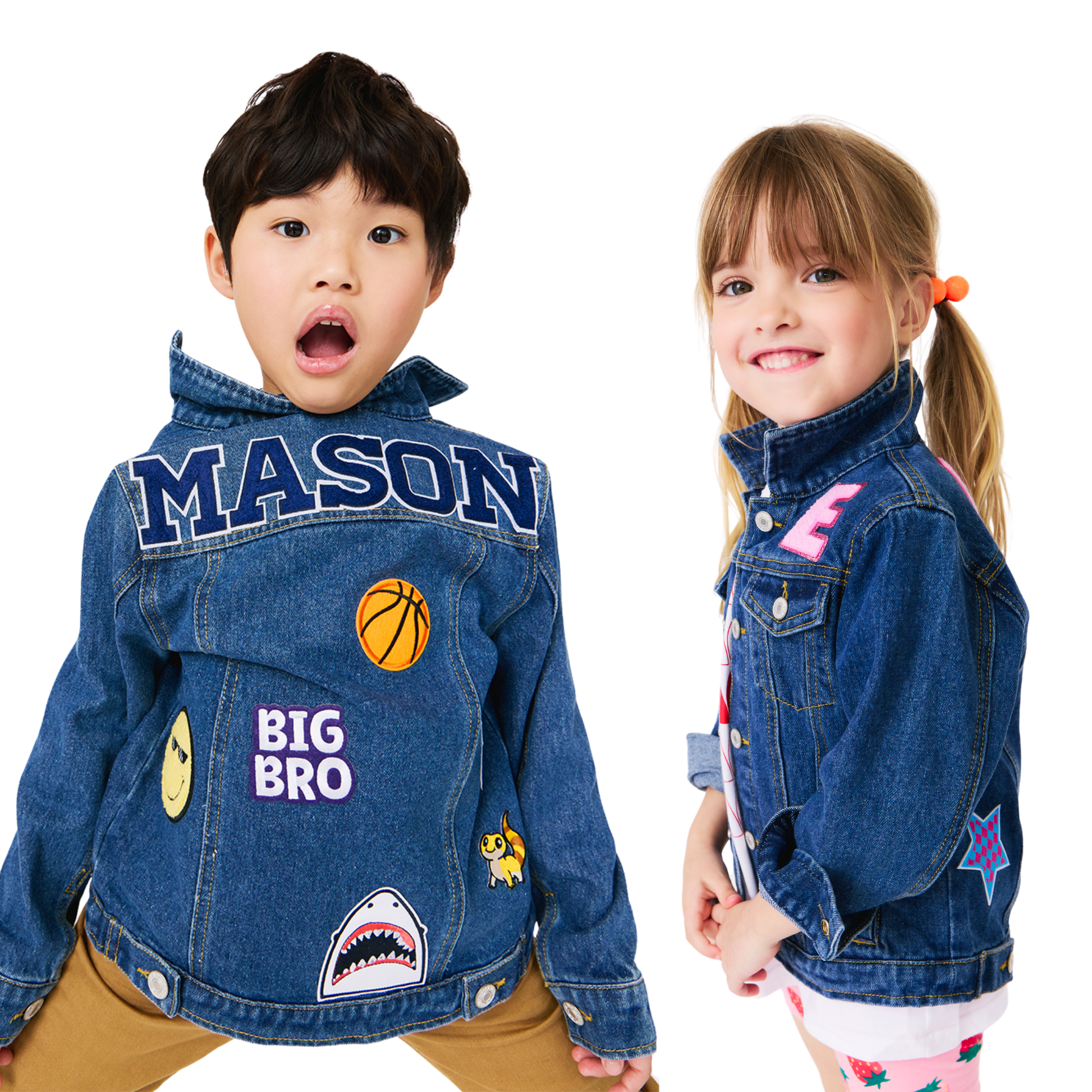 Two children wearing custom denim jackets with various patches on a white background