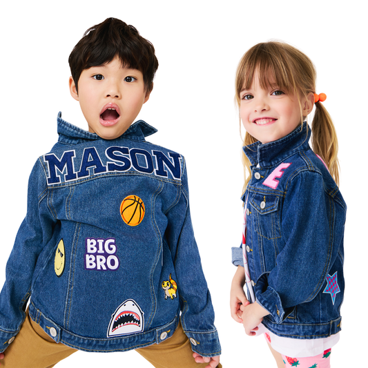 Two children wearing custom denim jackets with various patches on a white background