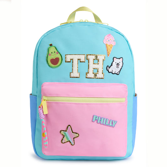 Personalized pastel kids backpack featuring custom initial patches, avocado, ice cream, puppy, star and city name patches. Includes front zip pocket, side pockets and spacious storage for school, camp and travel.