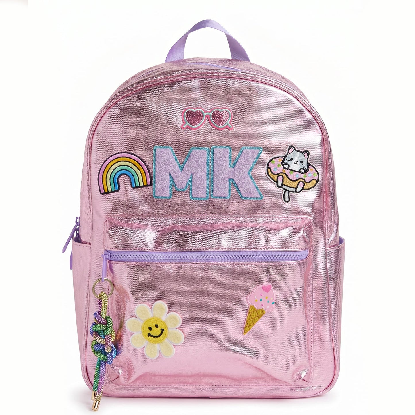 Personalized metallic pink kids backpack with custom initials and colorful patches including a rainbow, smiley flower, cat, ice cream cone and heart sunglasses. Features a front zip pocket, side pockets and spacious storage for school, camp and travel.