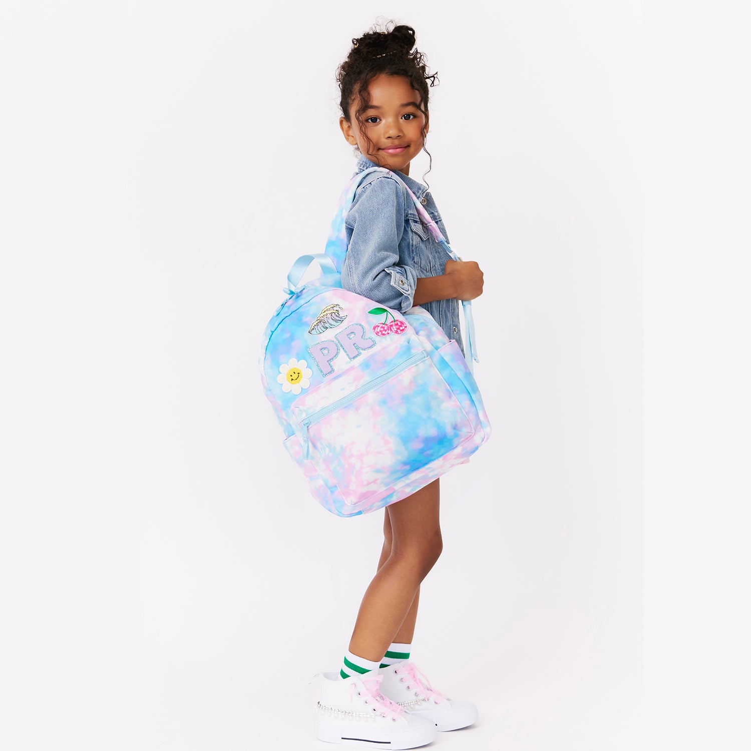 girl holding personalized pink tie dye backpack