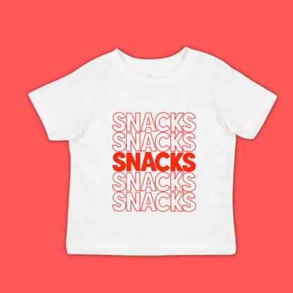 A white unisex kids' t-shirt with the word 'SNACKS' printed in red letters multiple times.