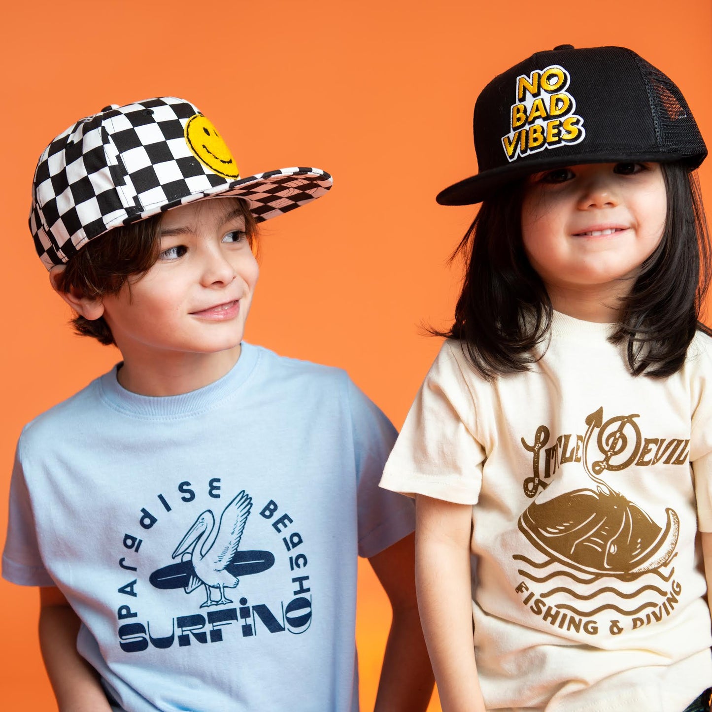 boy wearing a Paradise Beach Surfing T-Shirt and a Little Chicken hat