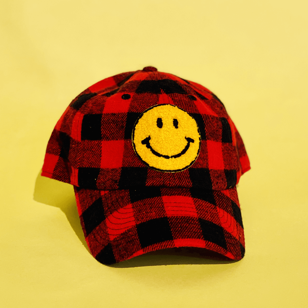 Buffalo plaid trucker hat with smiley face patch
