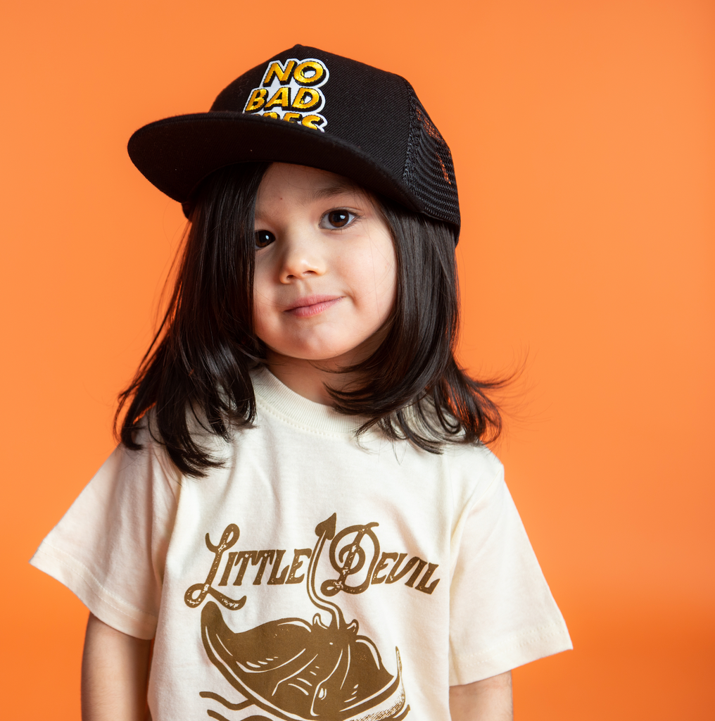 Little girl wearing a Kids Custom Trucker Hat 