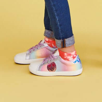 girl wearing kids leather sneakers in Dolly style in rainbow colors with smiley emoji detail